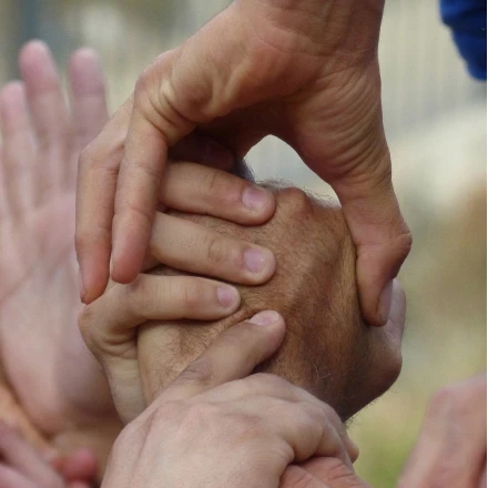 Hands joining together symbolizing collaborative governance and peace building